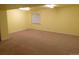Spacious, unfinished basement area with neutral carpet and bright, overhead lighting at 3212 S Kirk Way, Aurora, CO 80013