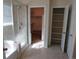 Bright bathroom with a glass shower, walk-in closet, and shelving for ample storage at 3212 S Kirk Way, Aurora, CO 80013