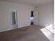 Neutral bedroom with plush carpeting and doorways leading to other rooms at 3212 S Kirk Way, Aurora, CO 80013