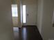 Inviting entryway with wood floors, natural light, and a view into another room at 3212 S Kirk Way, Aurora, CO 80013