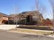 Beautiful home featuring a well-manicured lawn, a two-car garage, and stone accents on the facade at 3212 S Kirk Way, Aurora, CO 80013
