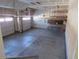 Spacious two-car garage with concrete floor and shelving for ample storage and workspace at 3212 S Kirk Way, Aurora, CO 80013