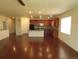A kitchen that opens to the living area with an island, pendant lights, and stainless steel appliances at 3212 S Kirk Way, Aurora, CO 80013