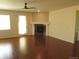 An open-concept space with fireplace, hardwood flooring, neutral paint, and a door to the outside at 3212 S Kirk Way, Aurora, CO 80013