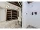 Unfinished basement with a utility sink and shelving for storage at 16293 E Brown Pl, Aurora, CO 80013