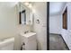 Bright bathroom with a white vanity, updated lighting, and a mirror door medicine cabinet at 16293 E Brown Pl, Aurora, CO 80013