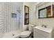 Updated bathroom featuring black and white tile shower, sleek vanity, and modern fixtures at 16293 E Brown Pl, Aurora, CO 80013