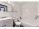 Bright white bathroom featuring tiled tub shower, white vanity and medicine cabinet at 16293 E Brown Pl, Aurora, CO 80013