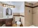 Bathroom with wood vanity, shower and tile with decorative accents at 16293 E Brown Pl, Aurora, CO 80013