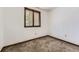 Carpeted bedroom with neutral paint, wood trim, and a window offering natural light at 16293 E Brown Pl, Aurora, CO 80013