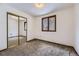 Bedroom with carpet, closet with mirrored sliding doors, and a window providing natural light at 16293 E Brown Pl, Aurora, CO 80013