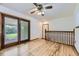Bright bonus room with wood floors, sliding glass door access to the backyard and ceiling fan at 16293 E Brown Pl, Aurora, CO 80013