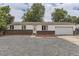 Charming single-story home featuring a brick facade, well-maintained lawn, and an attached garage at 16293 E Brown Pl, Aurora, CO 80013