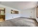 Cozy living room featuring neutral carpet and view to kitchen at 16293 E Brown Pl, Aurora, CO 80013