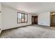 Bright living room with neutral carpet, and large window at 16293 E Brown Pl, Aurora, CO 80013