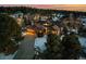 Aerial view of two story house at dusk, snowy yard, and neighborhood at 1535 Plowman Dr, Monument, CO 80132