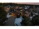 Aerial view of two story house at dusk, snowy yard, and neighborhood at 1535 Plowman Dr, Monument, CO 80132