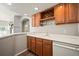 Basement wet bar with wood cabinets and wine rack at 1535 Plowman Dr, Monument, CO 80132