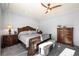 Well-lit bedroom with a wooden sleigh bed and dresser at 1535 Plowman Dr, Monument, CO 80132