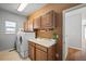 Laundry room with washer, dryer, cabinets, and a sink at 1535 Plowman Dr, Monument, CO 80132