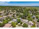 Aerial view of the neighborhood with mature trees and distant water views at 11969 E Lake Cir, Greenwood Village, CO 80111