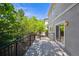 Back deck with black metal railing, slider doors and wooded backyard at 11969 E Lake Cir, Greenwood Village, CO 80111