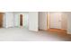 Finished basement featuring neutral carpet, mirrored wall, and white doors at 11969 E Lake Cir, Greenwood Village, CO 80111