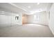Spacious carpeted basement featuring a large mirrored wall and a window at 11969 E Lake Cir, Greenwood Village, CO 80111