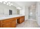 Bright bathroom with double sinks, a shower, and tile flooring at 11969 E Lake Cir, Greenwood Village, CO 80111