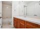 Bathroom with wood cabinets, white tile countertop, and shower-over-tub at 11969 E Lake Cir, Greenwood Village, CO 80111
