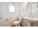 Simple half bathroom featuring a pedestal sink and wood flooring at 11969 E Lake Cir, Greenwood Village, CO 80111