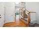 Bright foyer featuring hardwood floors and a staircase with wood banisters at 11969 E Lake Cir, Greenwood Village, CO 80111