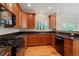 Kitchen features granite counters, wood cabinets, and stainless appliances at 11969 E Lake Cir, Greenwood Village, CO 80111