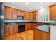 Kitchen with granite countertops, wood cabinets, and stainless steel appliances at 11969 E Lake Cir, Greenwood Village, CO 80111