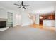 Spacious living room featuring a fireplace, open floor plan, and stairs to the upper level at 11969 E Lake Cir, Greenwood Village, CO 80111