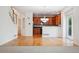 Hardwood floors leading to a kitchen with wood cabinets and stainless steel appliances at 11969 E Lake Cir, Greenwood Village, CO 80111