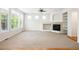 Cozy living room with a fireplace, ceiling fan, and large windows for natural light at 11969 E Lake Cir, Greenwood Village, CO 80111