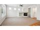 Inviting living room with fireplace, built-in shelves, and a ceiling fan at 11969 E Lake Cir, Greenwood Village, CO 80111