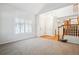 Open-concept living area featuring shuttered windows and a staircase at 11969 E Lake Cir, Greenwood Village, CO 80111