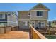 Exterior view of the home showcasing a wooden deck and a sliding glass door, ideal for indoor-outdoor living at 4405 Walden Ct, Denver, CO 80249