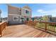 Backyard view with wooden deck, houses, and trampoline at 4405 Walden Ct, Denver, CO 80249