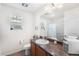 The bathroom features a large mirror, a window, a vanity, and a toilet at 4405 Walden Ct, Denver, CO 80249
