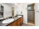 Bright bathroom showcases a double sink vanity, tiled shower, and ample storage space at 4405 Walden Ct, Denver, CO 80249