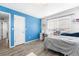 This bedroom has a large window, with blue accent wall and white trim at 4405 Walden Ct, Denver, CO 80249