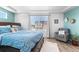 Well-lit bedroom with hardwood floors, natural light, a large bed, and a sitting area at 4405 Walden Ct, Denver, CO 80249