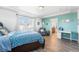 Bright bedroom boasts a connecting ensuite, ample natural light from the large windows, and stylish, modern finishes at 4405 Walden Ct, Denver, CO 80249