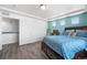 A cozy bedroom featuring a walk-in closet, a large window, and an accent wall at 4405 Walden Ct, Denver, CO 80249