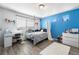 Bedroom features a bright blue wall, a window letting in natural light, and sleek wood-look flooring at 4405 Walden Ct, Denver, CO 80249