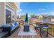Inviting wooden deck with outdoor seating, grill, and fire pit, perfect for entertaining at 4405 Walden Ct, Denver, CO 80249