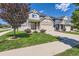 Inviting two-story home with a manicured lawn, complemented by a two-car garage and picturesque landscaping at 4405 Walden Ct, Denver, CO 80249